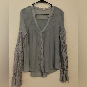 Light blue, button up top with cute sleeve detail. Size medium